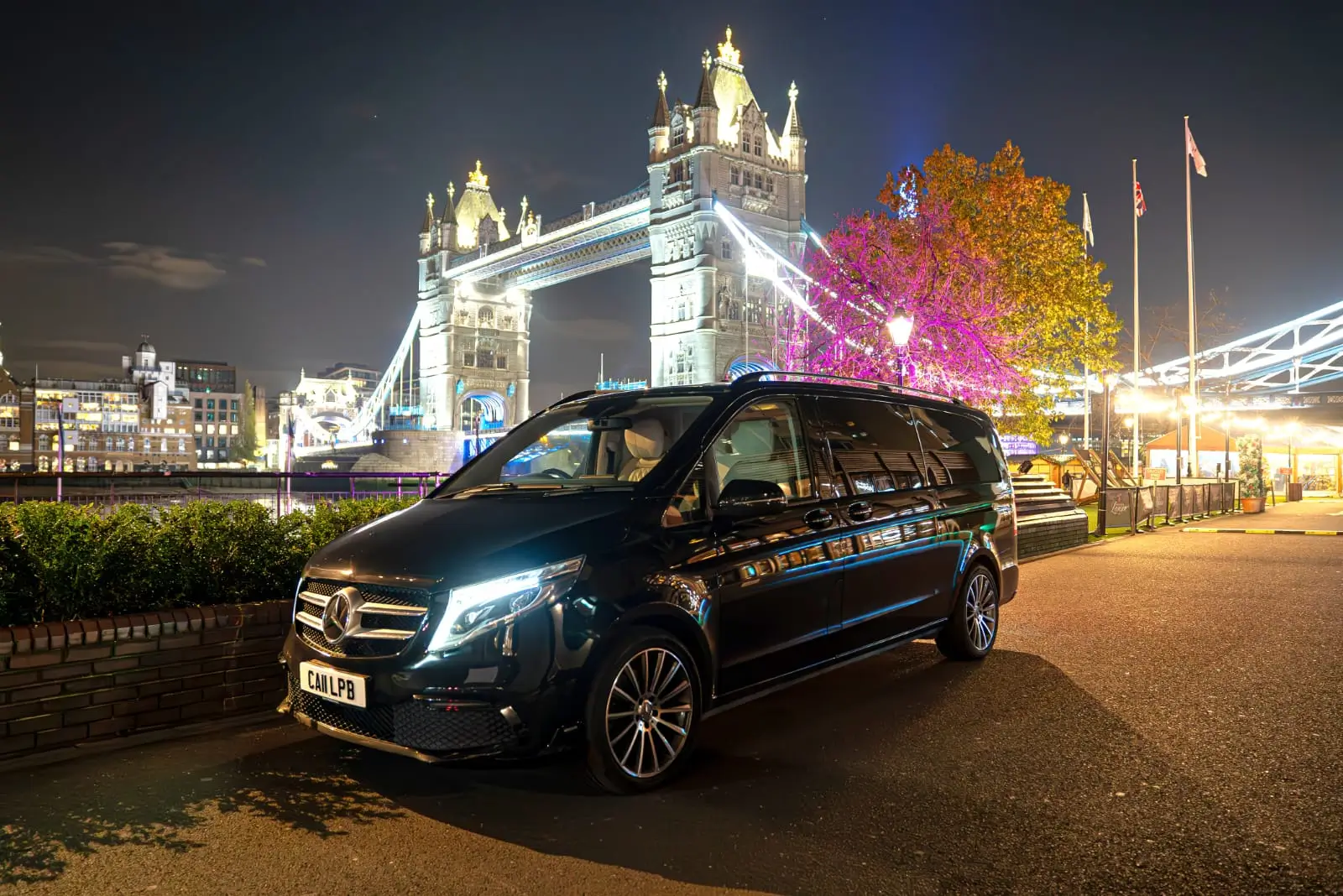 Luxury chauffeur car near Tower Bridge at night