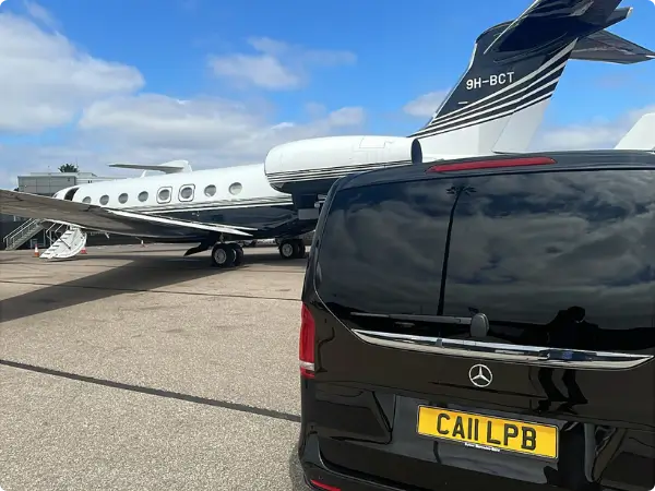 Private jet and chauffeur vehicle on runway