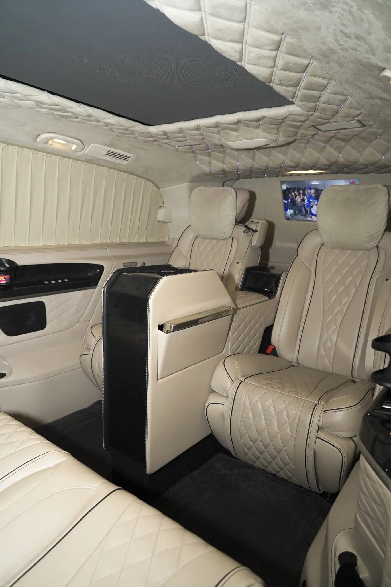 Luxury chauffeur van interior with white leather seating
