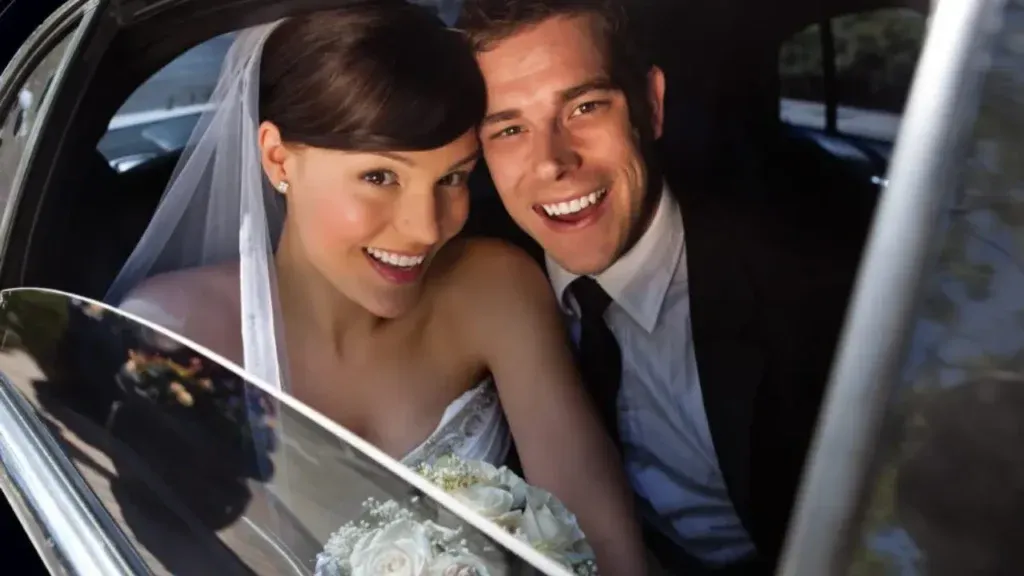 Bride and groom in luxury wedding chauffeur car